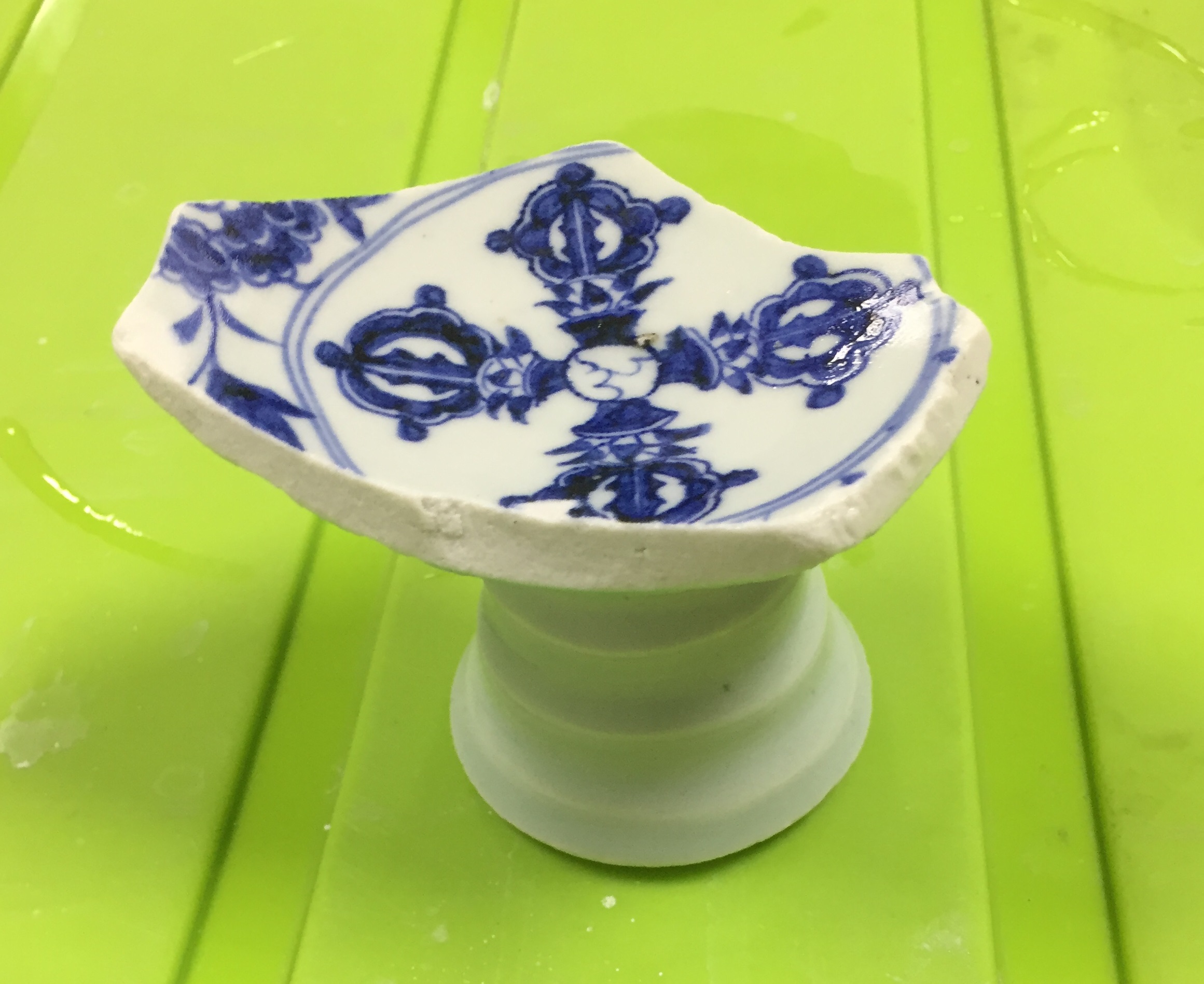 Blue-and-white stem-bowl shard with cross-vajra decoration from SW1